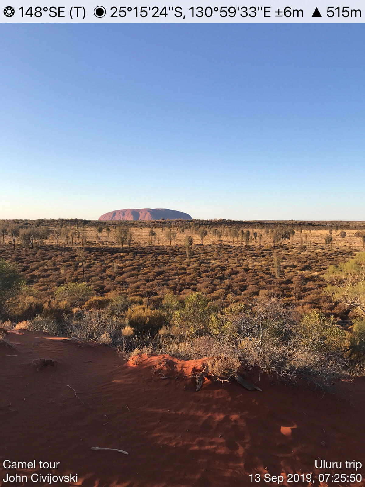 Red soil and shrubs at Uluru.