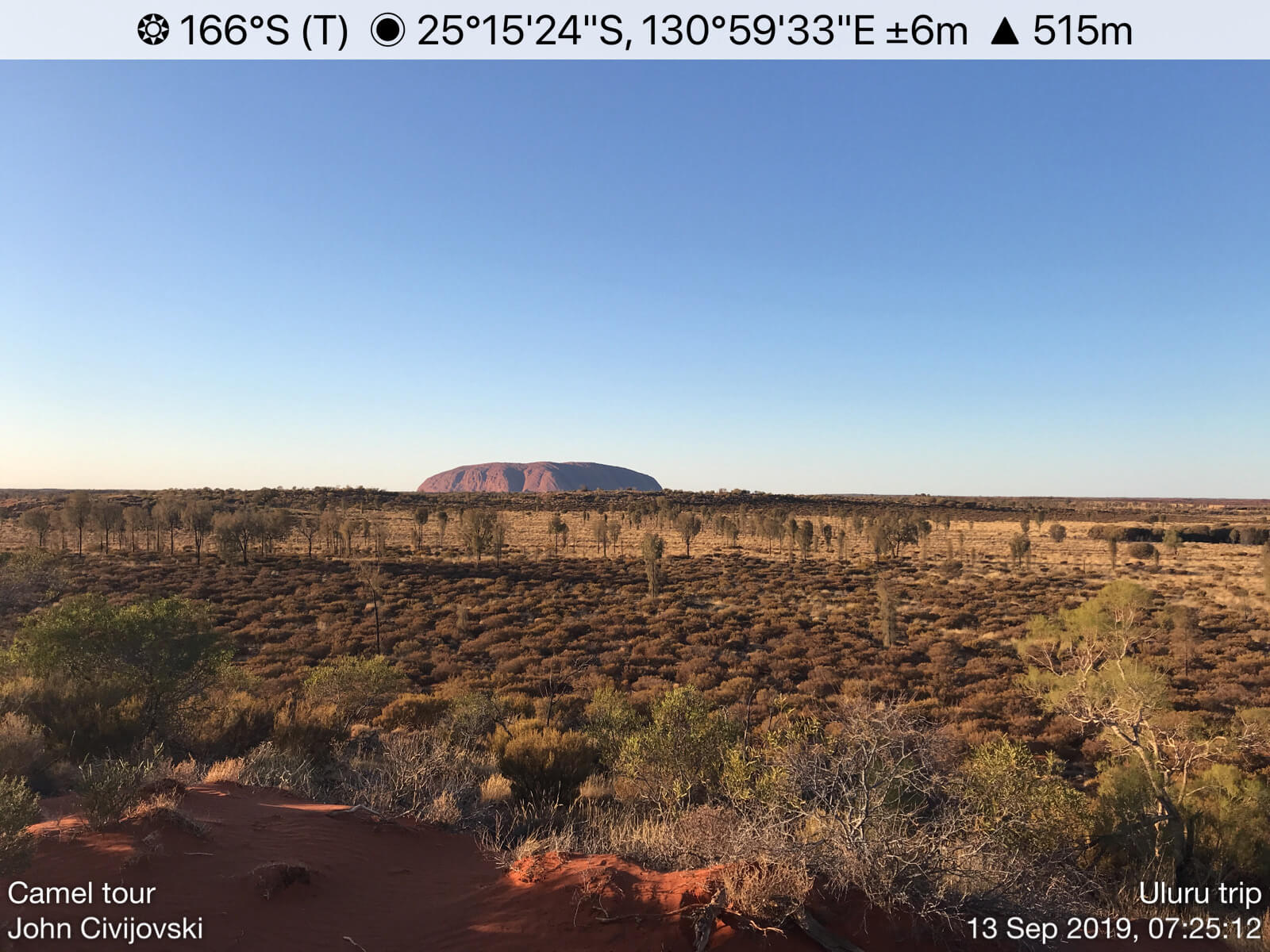 Ayers Rock in the distance.