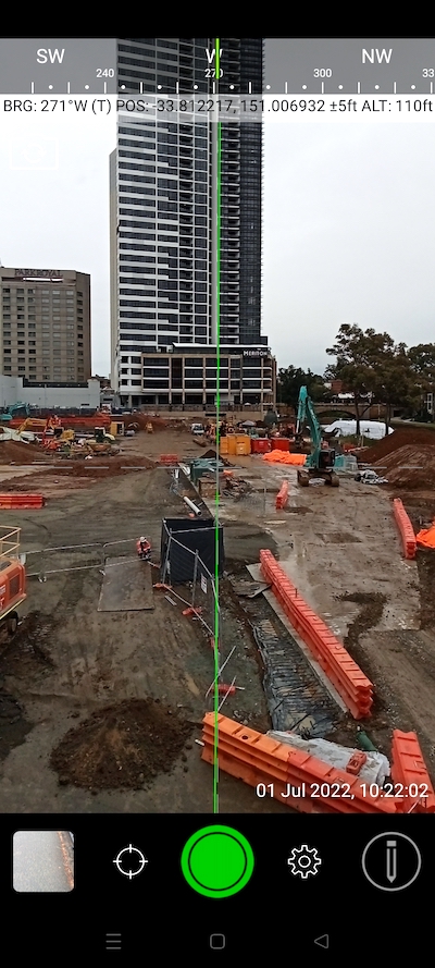 Construction site with compass and geo coordinates overlaid.